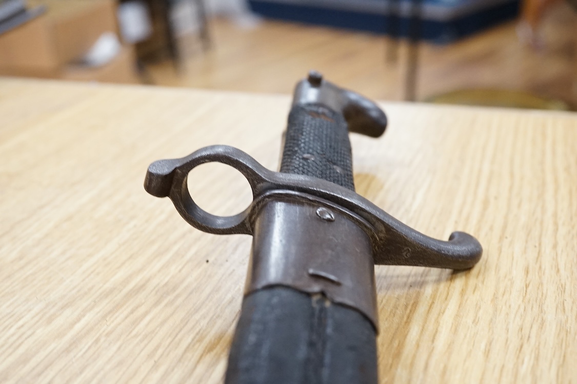 A Prussian M1865 bayonet and scabbard, blade marked with A&AS (for August & Albert Schnitzier), and Wilhelm I crown
